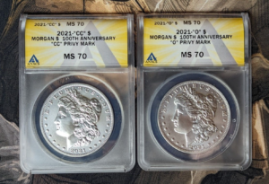 Two 2021 Morgan silver dollars. One Carson City mint. One New Orleans mint. Certified perfect MS 70 condition with certification boxes and paperwork.